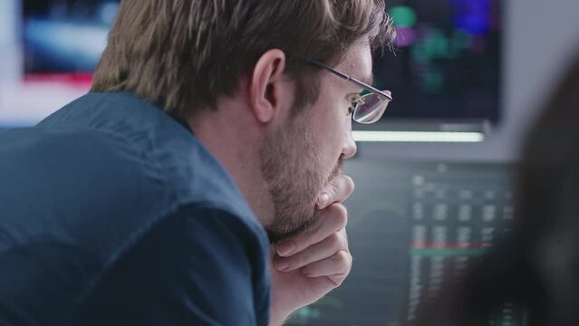 Financial analysts, businesspeople monitor real-time stocks and exchange market charts on PC, work in bank office. Big digital screen on background. Cryptocurrency trading and investment. Close up.