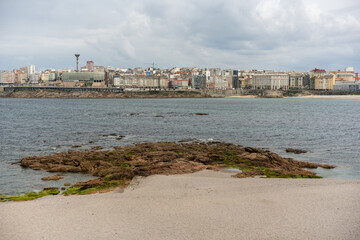 Fototapeta na wymiar panoramic view of the city and the sea of La Coruña in Galicia, Spain, from the rocky coastline