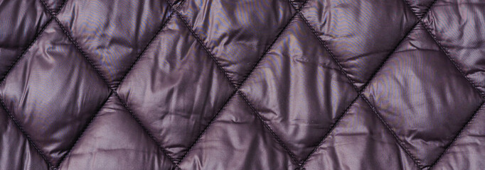 Quilted fabric background texture blanket or puffer jacket.padded, down jacket. Background of urban...
