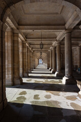 corridor with columns with perspective in vanishing point where light and shadow are mixed