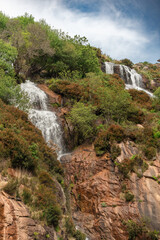 Fototapeta na wymiar natural landscape of the tree-filled mountain waterfall of the Ézaro in Dumbria, La Coruña, Galicia, Spain