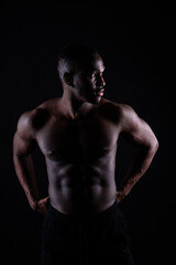 Muscle, body and skin, portrait of black man on dark background with serious face for art aesthetic.