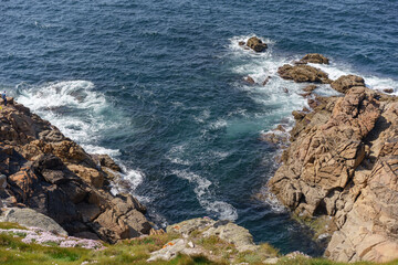 Fototapeta na wymiar coastal image of foam formed by sea waves crashing against rock formations in La Coruña, Galicia