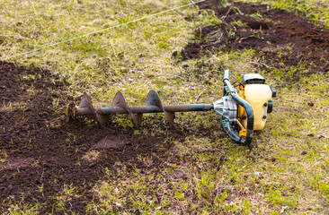 Worker digs the ground with a gasoline blower in the garden