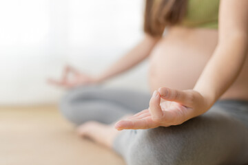 Pregnant woman practicing yoga and meditation