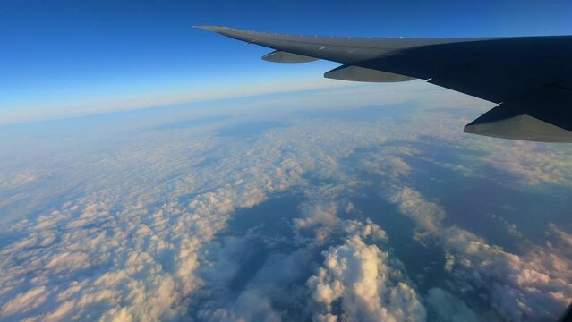 Horizon line on blue sky and white clouds, view from window seat airplane, flight to holiday, travel, tour and journey world 
