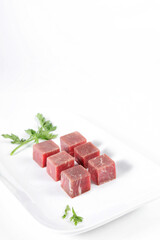 Beef cut into cubes, table top on white background
