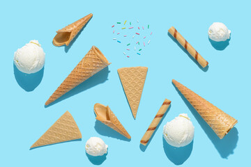 top view scoops of ice cream cone, sprinkles, cigars and fans on blue with hard shadow, summer concept