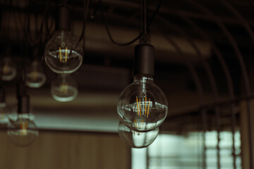 Fototapeta na wymiar Edison lamp in the loft style in the office, coworking space