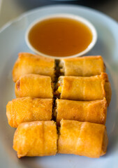  Fried Chinese Traditional Spring rolls food in ceramic plate (beautiful shape) on white background