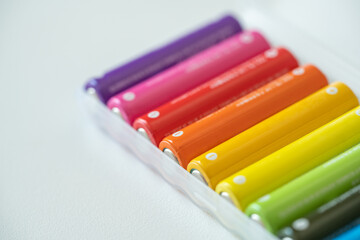 New colorful AAA battery in plastic box, rechargeable accumulator, closeup of alkaline batteries on...