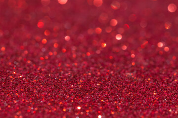 Defocused red glitter background.Shiny red background.Beautiful bright holiday abstract red glitter...