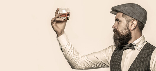 Portrait of man with thick beard. Macho drinking. Bearded gentleman drink cognac. Stylish rich man...