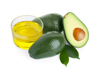 Bowl with oil and fresh avocados on white background