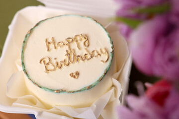 Fototapeta na wymiar Delicious decorated Birthday cake and beautiful flowers indoors, closeup