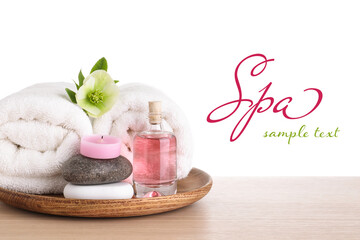 Tray with spa supplies on wooden table against white background. Design with space for text