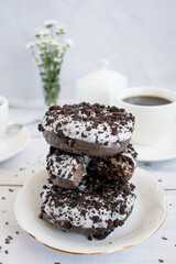 Chocolate donuts with cup of coffee. on white wooden table.