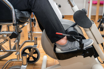 An unrecognizable elderly woman does pedal exercises from wheel chair at hospital. High quality...