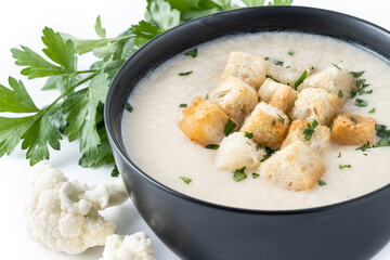 Cauliflower soup in a bowl isolated on white background.Close up