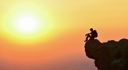 The Man Watching the Magnificent Colors of the Sunset