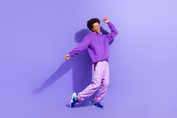 Full size photo of good mood person wear violet hoodie sport pants shout celebrate winning lottery...
