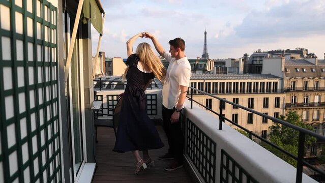 Romantic Couple Dancing on Rooftop Balcony in Paris, France by Eiffel Tower