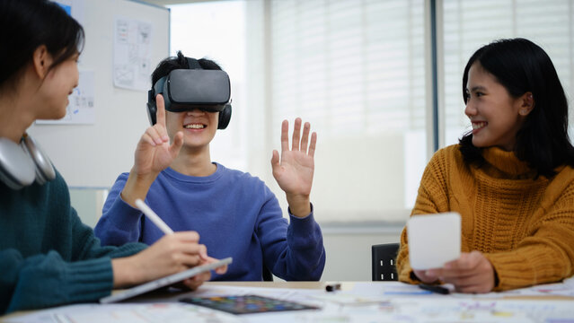 Team Of Developers Is Brainstorming, Testing Virtual Reality Simulator Glasses At Meeting, Future Technology For Business Concept