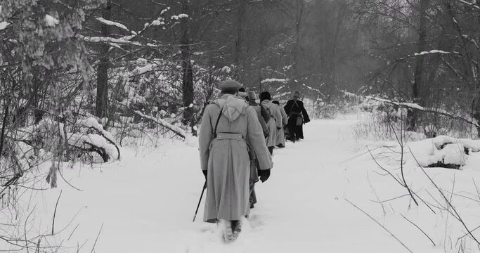 Army on Marching. Men Dressed As White Guard Soldiers Of Imperial Russian Army In Russian Civil War s Marching Through Snowy Winter Forest. Historical Reenactment of Civil War. Black And White Video.