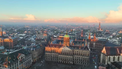 Foto op Plexiglas 4k Aerial view of famous places Amsterdam, Netherlands. View of canal and old centre district. Koninklijk Paleis Amsterdam view at sunrise © Dmytro Kosmenko