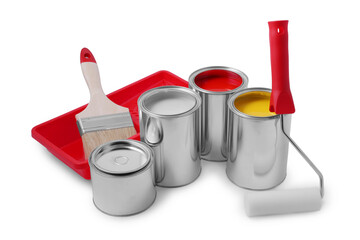 Cans of different paints, roller, brush and tray on white background