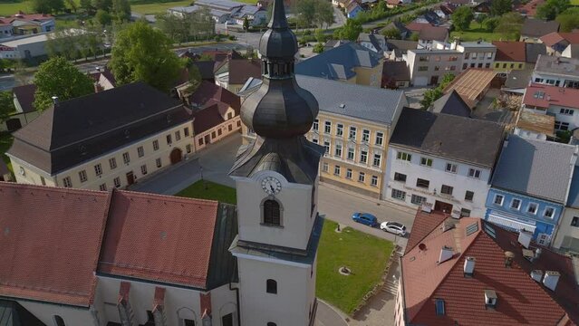 Village church bell tower. Lovely aerial top view flight 
Church in village Heidenreichstein, city in Austria Europe, summer day of 2023. panorama orbit drone
4K uhd cinematic footage.