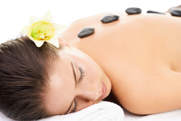 Hot stones, luxury spa and woman relax on massage bed on isolated, png and transparent background....