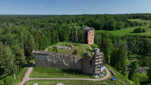 Slowly approaching aerial view of ruins of Vastseliina Episcopal Castle in Estonia.