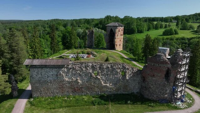 Slowly approaching aerial view of ruins of Vastseliina Episcopal Castle. Estonia.