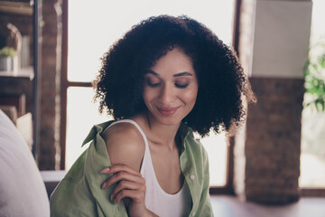 Closeup portrait of nice attractive lady touching her khaki dressed shirt flirt coquette sitting cozy free shoulder indoors loft interior
