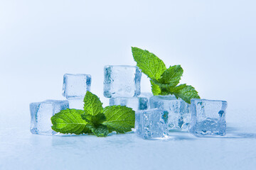 Ice cubes and fresh mint leaves, isolated on blue background  © zhikun sun