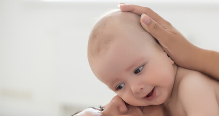 happy family. Mother and baby playing and smiling on bed