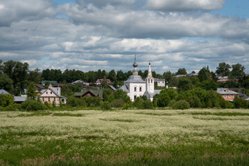 View of Ilyinsky Meadow, the Church of the Nativity of John the Baptist and the Church of the Epiphany on a sunny summer day, Suzdal, Vladimir region, Russia
