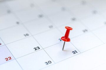 Red push pin on calendar 31st day of the month, new year eve