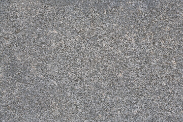 Granite texture. Natural gray granite with a grainy pattern. Stone background. Solid rough surface of rock. Durable construction and decoration material. Close-up. - obrazy, fototapety, plakaty