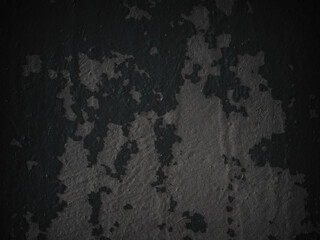 Dark background texture. Peeling paint on a concrete wall. Dark grunge texture of old cracked flaking paint. Weathered rough painted surface. Patterns of cracks. Darkness grungy background for design.