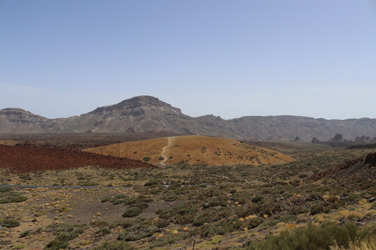 Panoramic view of volcanic lanscape in front of the ocean from the peak of mountain Teide, Tenerife