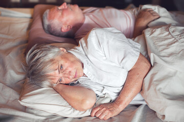 Obraz na płótnie Canvas Sad seniors couple in bed at home