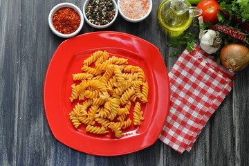 Fusilli pasta in tomato sauce. gray background. Italian food concept