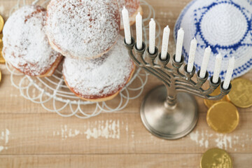 Happy Hanukkah. Hanukkah old Menorah against background of the Israeli flag with sunlight or bokeh...