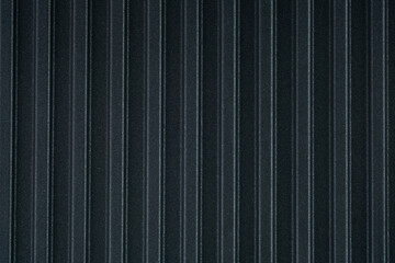 Black relief striped metal sheet wall, fence or roof texture with vertical stripes. Abstract textured. Top View from above.