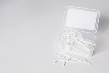 Dental toothpicks with dental floss in box on white