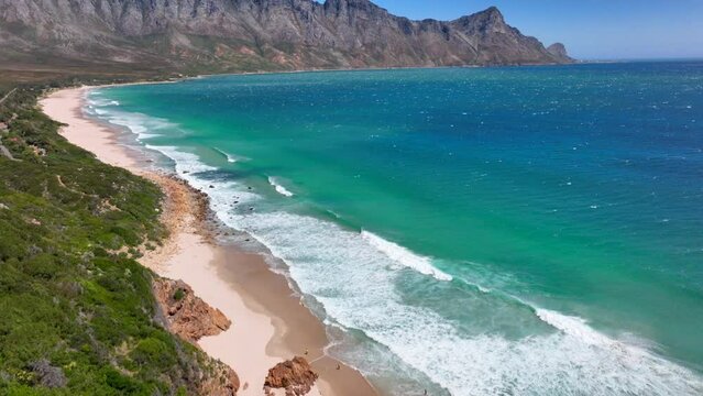 Koeel Bay Dappat Se Gat drone aerial cinematic windy surf waves crashing stunning Kogel Bay Beach Cape Town South Africa coastline aqua deep blue water Gordon's Bay  Garden Route forward pan up motion