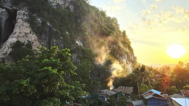Drone shots of bats leaving their cave at sunset (Bat Exodus) in Battambang, Cambodia