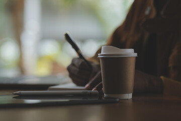 Close up of accountant working and analyzing financial reports project accounting with chart graph and calculator in modern office : finance and business concept.